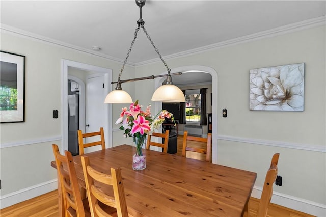 44 Felsmere Ave, Pawtucket, RI 02861 - dining space featuring arched walkways, crown molding, wood finished floors, and baseboards