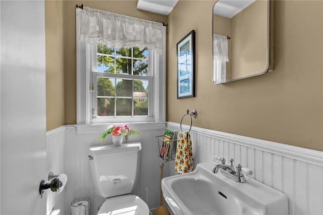 44 Felsmere Ave, Pawtucket, RI 02861 - bathroom featuring a wainscoted wall, a sink, toilet, and a decorative wall
