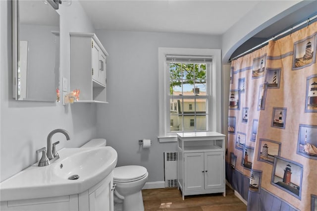 44 Felsmere Ave, Pawtucket, RI 02861 - full bath featuring radiator heating unit, toilet, baseboards, wood finished floors, and vanity
