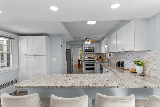 44 Felsmere Ave, Pawtucket, RI 02861 - kitchen with appliances with stainless steel finishes, a sink, radiator heating unit, a ceiling fan, and healthy amount of natural light