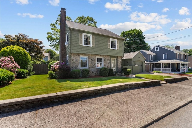 44 Felsmere Ave, Pawtucket, RI 02861 - colonial home with stone siding, a chimney, a garage, and driveway
