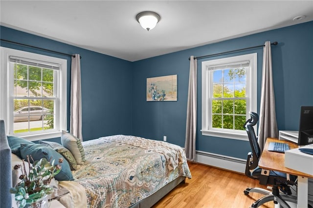 299 Buttonwoods Ave, Warwick, RI 02886 - bedroom featuring baseboard heating, light wood-style floors, a desk, and baseboards