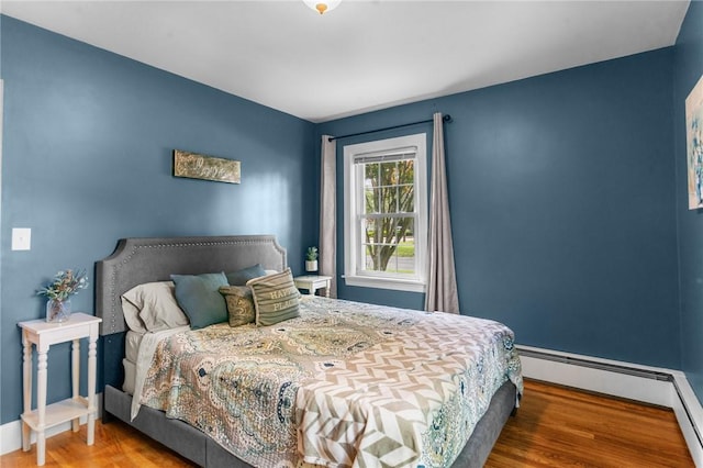 299 Buttonwoods Ave, Warwick, RI 02886 - bedroom with baseboard heating, wood finished floors, and baseboards