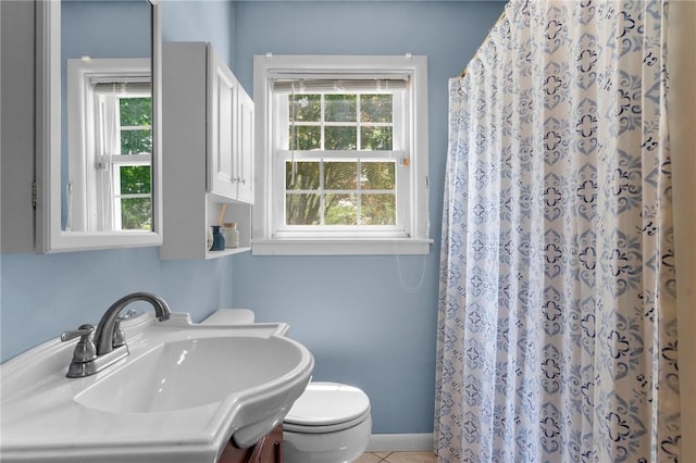 299 Buttonwoods Ave, Warwick, RI 02886 - bathroom featuring healthy amount of natural light, toilet, a sink, and tile patterned floors
