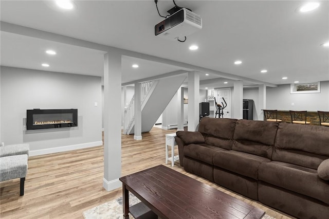 299 Buttonwoods Ave, Warwick, RI 02886 - living area featuring light wood-style flooring, stairway, recessed lighting, a glass covered fireplace, and baseboards