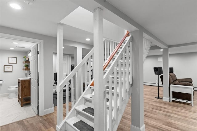 299 Buttonwoods Ave, Warwick, RI 02886 - stairway featuring a baseboard radiator, recessed lighting, baseboards, and wood finished floors