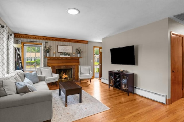 299 Buttonwoods Ave, Warwick, RI 02886 - living area with a baseboard radiator, light wood finished floors, and a fireplace
