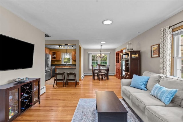 299 Buttonwoods Ave, Warwick, RI 02886 - living room with light wood-type flooring, a chandelier, a baseboard radiator, and recessed lighting