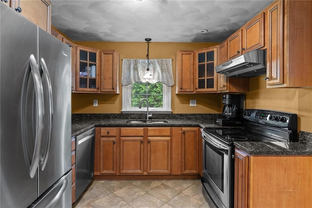 299 Buttonwoods Ave, Warwick, RI 02886 - kitchen featuring stainless steel appliances, under cabinet range hood, a sink, brown cabinets, and dark stone countertops