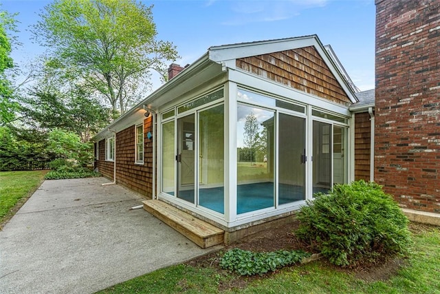 37 Beaumont St, East Providence, RI 02916 - view of side of property featuring a sunroom, a patio, and a chimney
