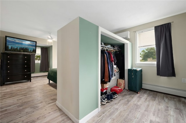 73 Vineyard Ave, Cumberland, RI 02864 - bedroom with wood finished floors, a baseboard radiator, and a closet