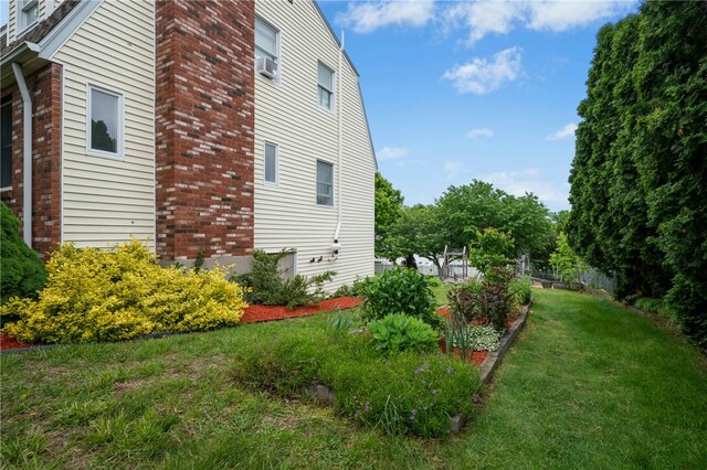 73 Vineyard Ave, Cumberland, RI 02864 - view of home's exterior with brick siding, a lawn, and a chimney