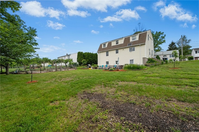 73 Vineyard Ave, Cumberland, RI 02864 - rear view of house with a gambrel roof, a yard, and a shingled roof