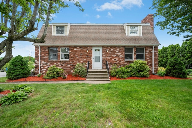 73 Vineyard Ave, Cumberland, RI 02864 - view of front of house with a front lawn, brick siding, a chimney, and roof with shingles
