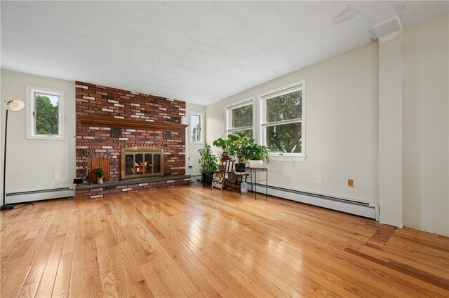 73 Vineyard Ave, Cumberland, RI 02864 - unfurnished living room featuring a baseboard radiator, wood-type flooring, and healthy amount of natural light
