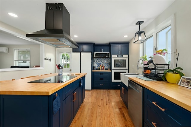 73 Vineyard Ave, Cumberland, RI 02864 - kitchen featuring wooden counters, blue cabinets, stainless steel appliances, wall chimney range hood, and a sink