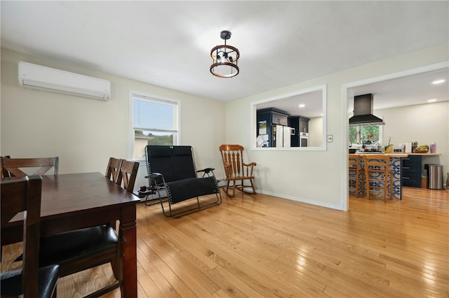 73 Vineyard Ave, Cumberland, RI 02864 - dining space featuring a wall mounted AC, light wood finished floors, and baseboards