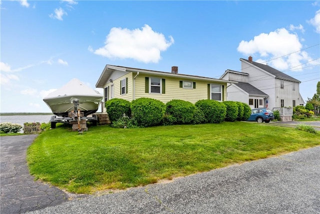 263 Prospect Rd, South Kingstown, RI 02879 - view of front of home featuring a front lawn and a chimney