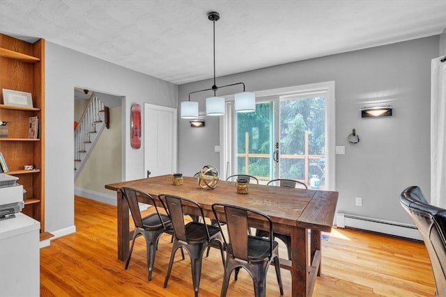 15 Boyd Ave, East Providence, RI 02914 - dining space featuring a baseboard heating unit, light wood-style flooring, stairs, and baseboards