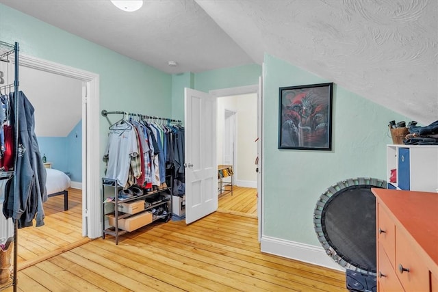 15 Boyd Ave, East Providence, RI 02914 - bedroom with light wood-type flooring, baseboards, a textured ceiling, and lofted ceiling