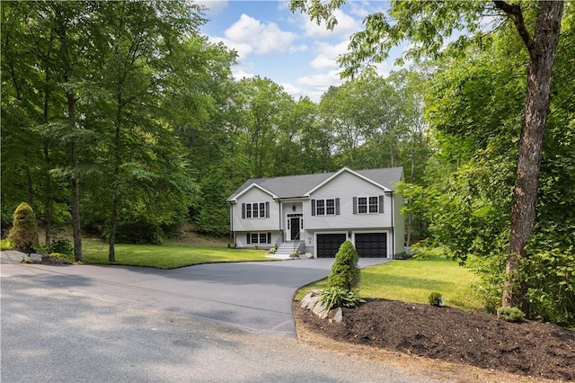 128 Old Quarry Rd, Glocester, RI 02857 - bi-level home with a garage, driveway, and a front lawn