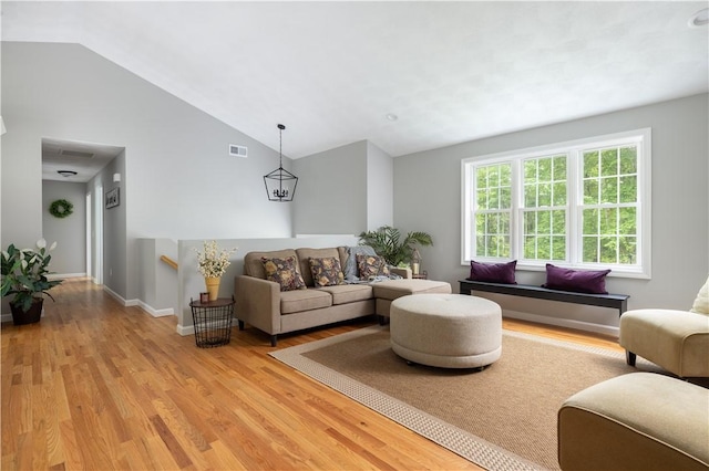 128 Old Quarry Rd, Glocester, RI 02857 - living room featuring vaulted ceiling, light wood-type flooring, and baseboards
