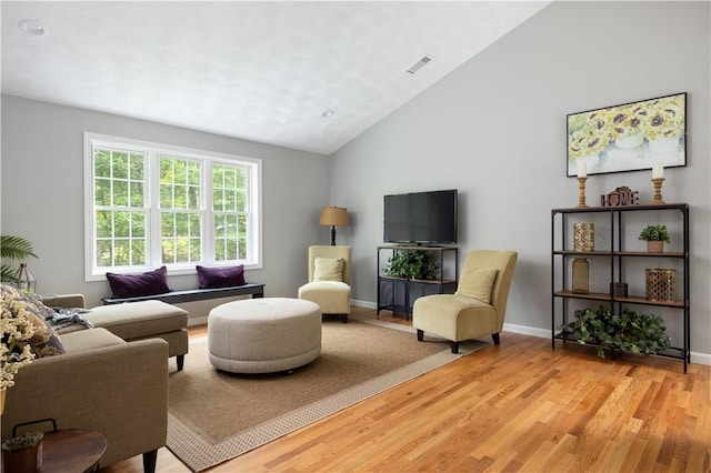 128 Old Quarry Rd, Glocester, RI 02857 - living area with light wood-style flooring, lofted ceiling, and baseboards