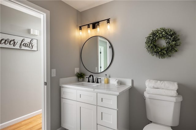 128 Old Quarry Rd, Glocester, RI 02857 - bathroom featuring vanity, toilet, wood finished floors, and baseboards