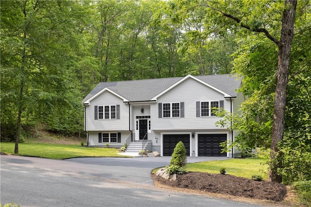 128 Old Quarry Rd, Glocester, RI 02857 - bi-level home featuring concrete driveway, an attached garage, a front yard, and a shingled roof