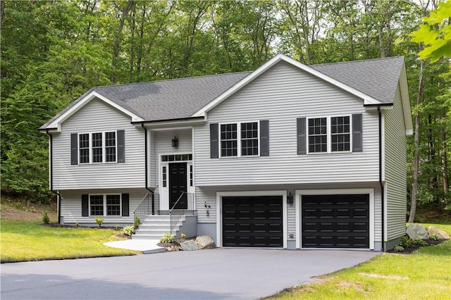 128 Old Quarry Rd, Glocester, RI 02857 - bi-level home featuring concrete driveway, an attached garage, a shingled roof, and a front yard