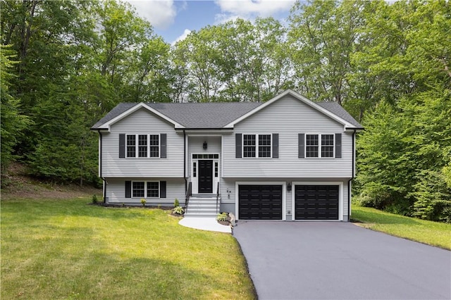 128 Old Quarry Rd, Glocester, RI 02857 - bi-level home featuring a garage, asphalt driveway, a front yard, and a shingled roof