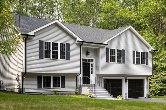 128 Old Quarry Rd, Glocester, RI 02857 - bi-level home featuring a garage, roof with shingles, a front lawn, and asphalt driveway