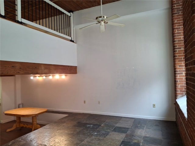 15 Higgins St Unit 106, Smithfield, RI 02917 - spare room with stone tile floors, ceiling fan, and a high ceiling