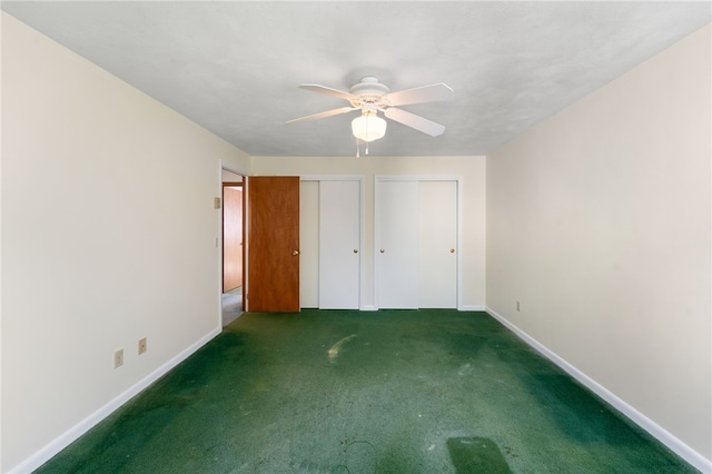 500 E Greenwich Ave Unit 108, West Warwick, RI 02893 - unfurnished bedroom with two closets, carpet floors, baseboards, and a ceiling fan