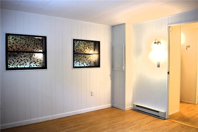 19 Jacob Perry Dr, Charlestown, RI 02831 - empty room featuring a baseboard heating unit, light wood-style flooring, and baseboards