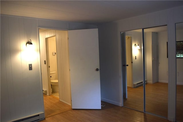 19 Jacob Perry Dr, Charlestown, RI 02831 - unfurnished bedroom with wood finished floors, baseboard heating, and ensuite bathroom