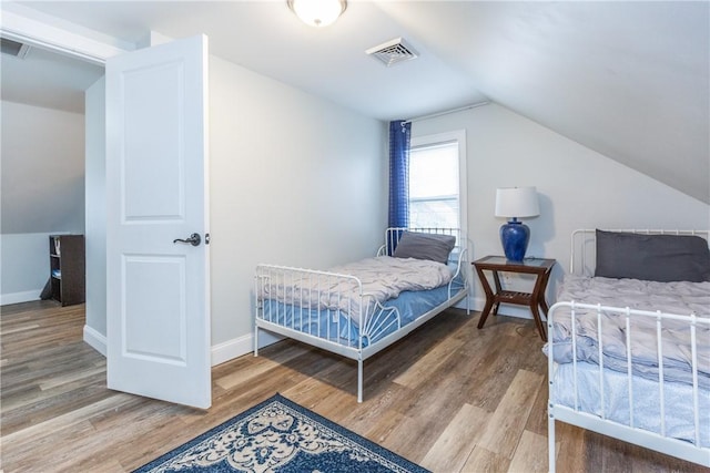 214 Silver Spring St, Providence, RI 02904 - bedroom with vaulted ceiling, wood finished floors, and baseboards