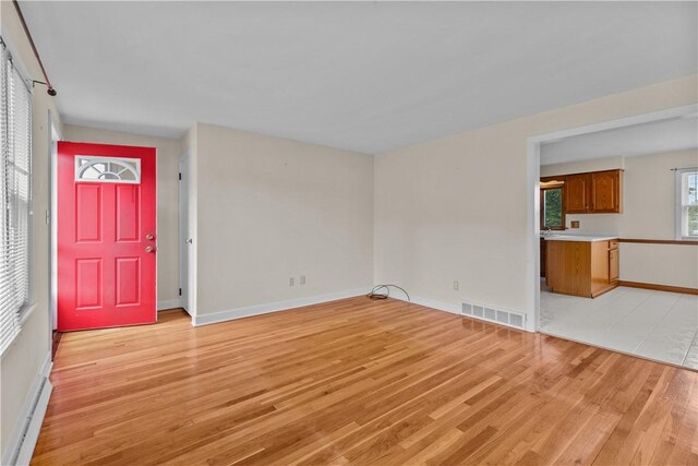 174 Russell Dr, Tiverton, RI 02878 - unfurnished living room featuring light wood-style flooring and baseboards