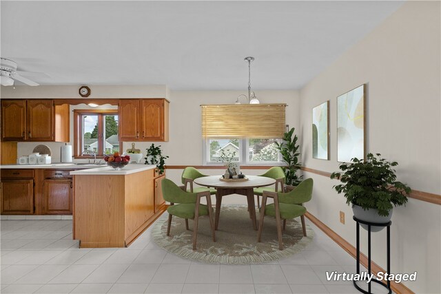 174 Russell Dr, Tiverton, RI 02878 - kitchen featuring light countertops, plenty of natural light, brown cabinets, and decorative light fixtures