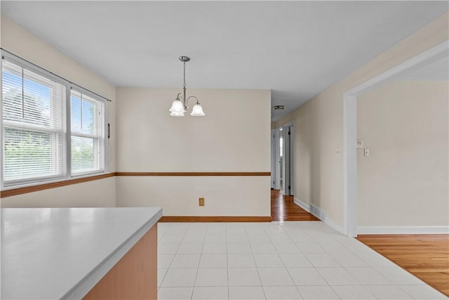174 Russell Dr, Tiverton, RI 02878 - unfurnished dining area featuring a chandelier and light tile patterned flooring
