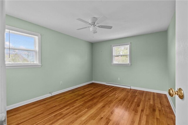 174 Russell Dr, Tiverton, RI 02878 - unfurnished room featuring a baseboard radiator, wood finished floors, and a ceiling fan