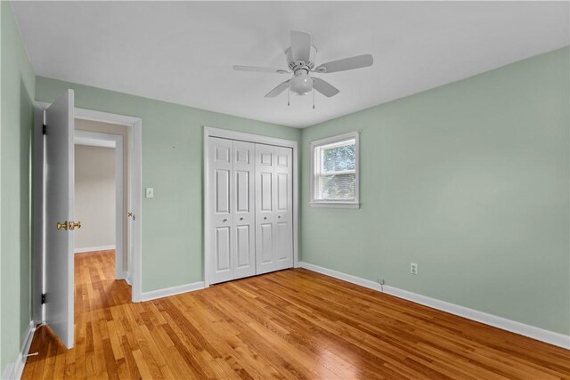 174 Russell Dr, Tiverton, RI 02878 - unfurnished bedroom with light wood-type flooring, a closet, and a ceiling fan