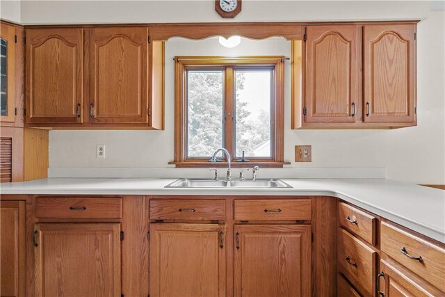 174 Russell Dr, Tiverton, RI 02878 - kitchen featuring light countertops and brown cabinets