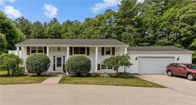 386 Mishnock Rd, West Greenwich, RI 02817 - bi-level home featuring driveway, an attached garage, and view of wooded area