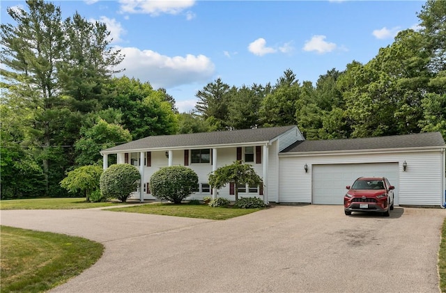 386 Mishnock Rd, West Greenwich, RI 02817 - bi-level home featuring driveway, a garage, and a front lawn
