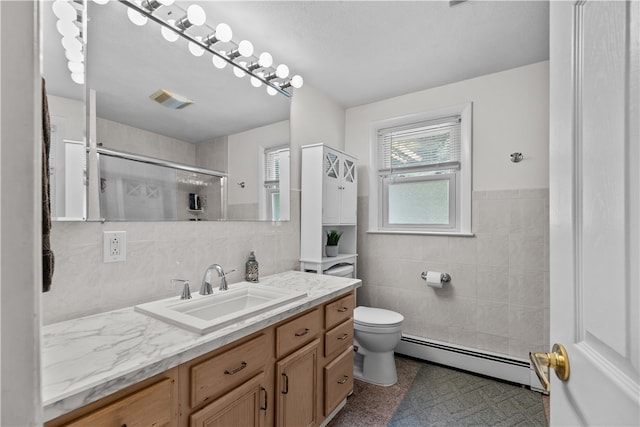 386 Mishnock Rd, West Greenwich, RI 02817 - bathroom with tile walls, baseboard heating, toilet, vanity, and a shower with shower door