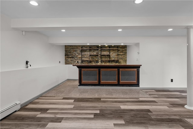 386 Mishnock Rd, West Greenwich, RI 02817 - detailed view of a baseboard heating unit, recessed lighting, bar area, wood finished floors, and baseboards