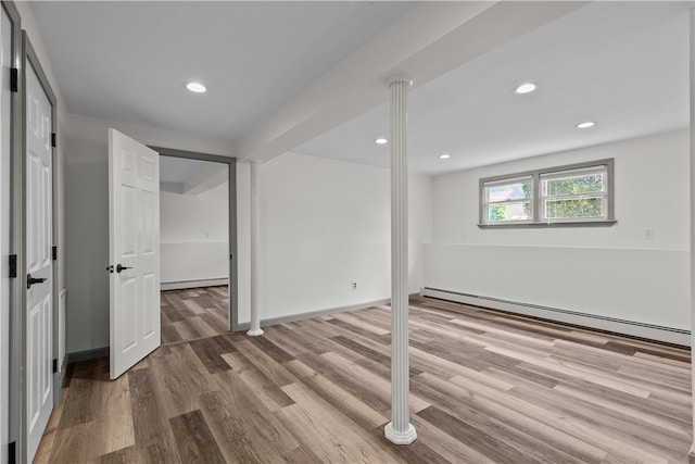 386 Mishnock Rd, West Greenwich, RI 02817 - below grade area with a baseboard heating unit, wood finished floors, baseboard heating, recessed lighting, and baseboards