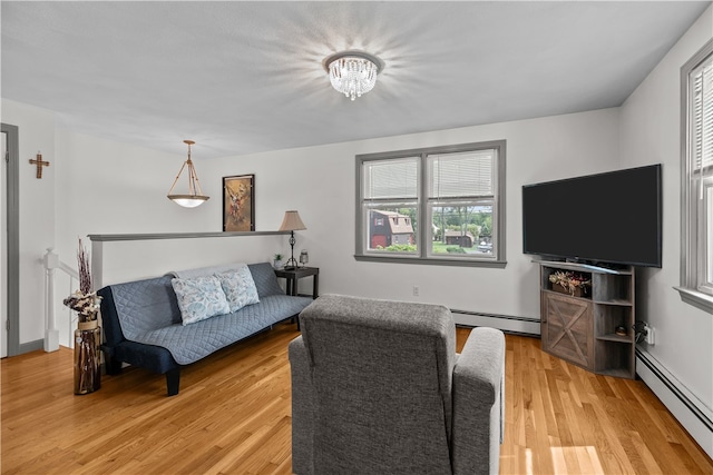 386 Mishnock Rd, West Greenwich, RI 02817 - living room featuring a baseboard heating unit, light wood-style floors, and a chandelier