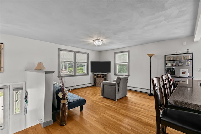 386 Mishnock Rd, West Greenwich, RI 02817 - living room featuring a baseboard radiator, a baseboard heating unit, and light wood-style floors